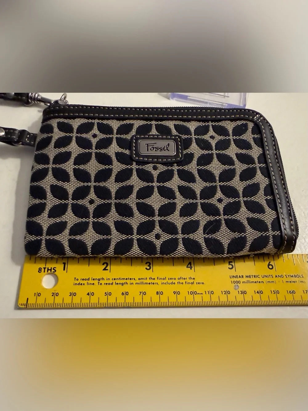 Fossil monogram canvas wristlet/wallet with leather trim.